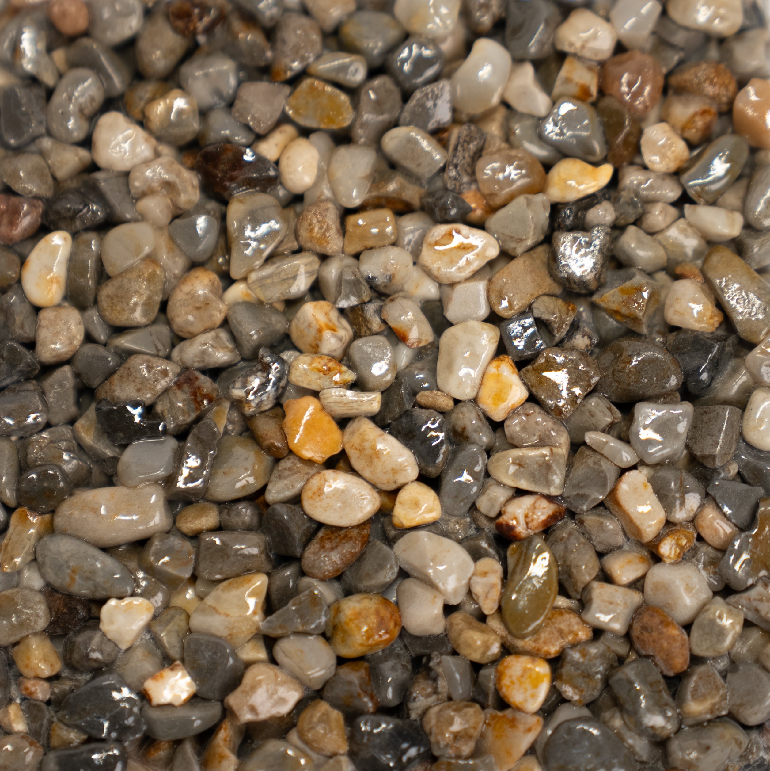 Multicolored gray stones that range from light to dark gray with hints of pink, red and orange colors.
