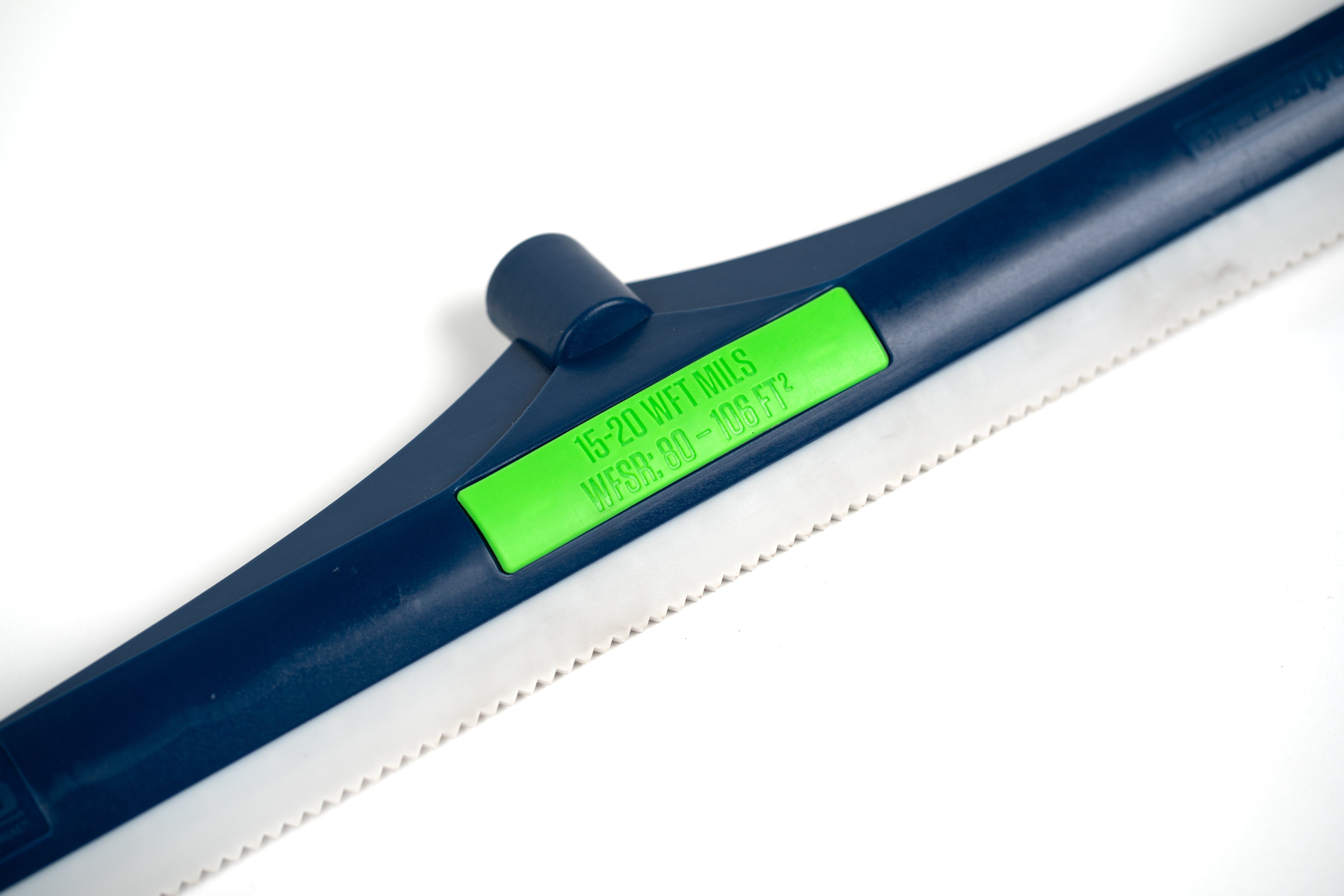 Small 24 inch, 15-20 mils, notched squeegee rake diagonal close up on front of rake