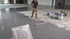 Contractor squeegeeing grey moisture barrier for concrete floor at 16 mils 